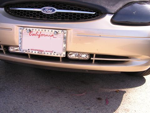 1993 Ford Taurus - Front view of a gold 1993 Ford Taurus, its grille and a California license plate.