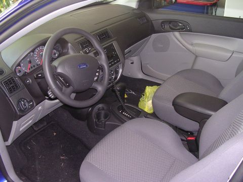 1985 Ford Bronco - The interior of a Ford Focus is shown, the driver's side controls and passenger seating.