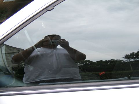 1998 Ford Taurus - A person's reflection is visible in the car window as they take a photo.