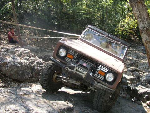 1995 Ford Bronco - Ford Bronco navigating a rocky off-road course.
