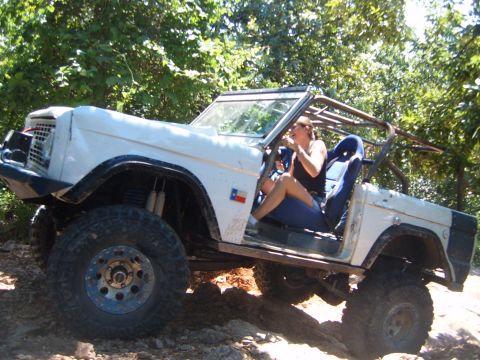 1988 Ford Bronco - This modified SUV, likely a Ford Bronco from the late 1970s, navigates a rocky trail.
