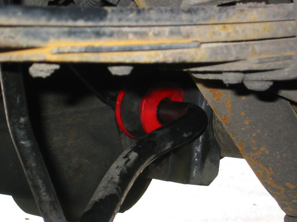 Red sway bar bushings installed on a black sway bar