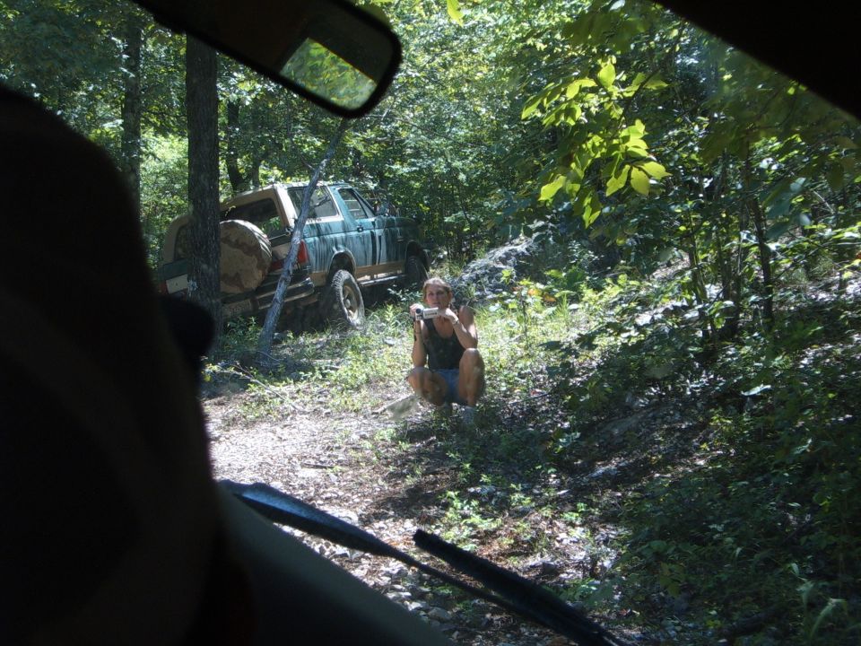 1988 Ford Bronco parked on wooded trail with spare tire on rear door