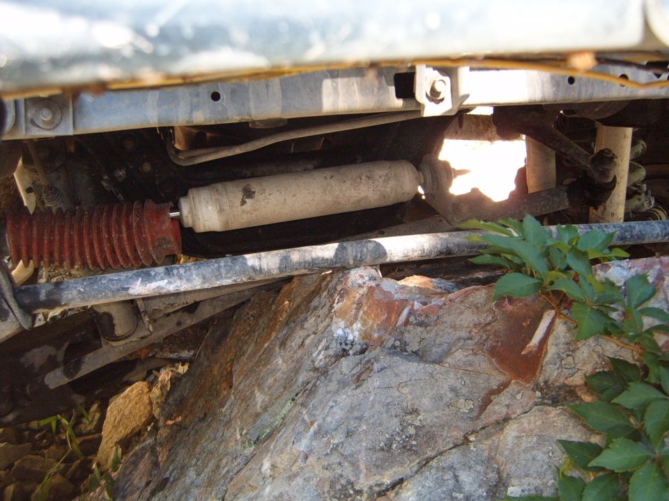 Undercarriage view of shock absorber with red bellows