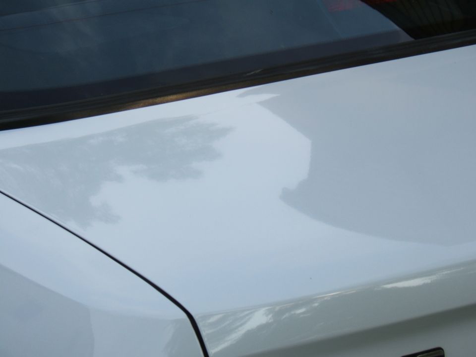 White car trunk and rear window with reflection