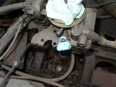 1973 Jeep CJ5 - Engine part with a blue tag, possibly an oil cap or identification marker.