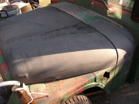 1973 Jeep CJ5 - Hood and fender of a 1973 Jeep CJ5, prepped for paint with primer and showing rust.