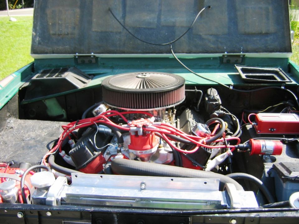Green Bronco engine bay with V8, chrome air cleaner and red plug wires