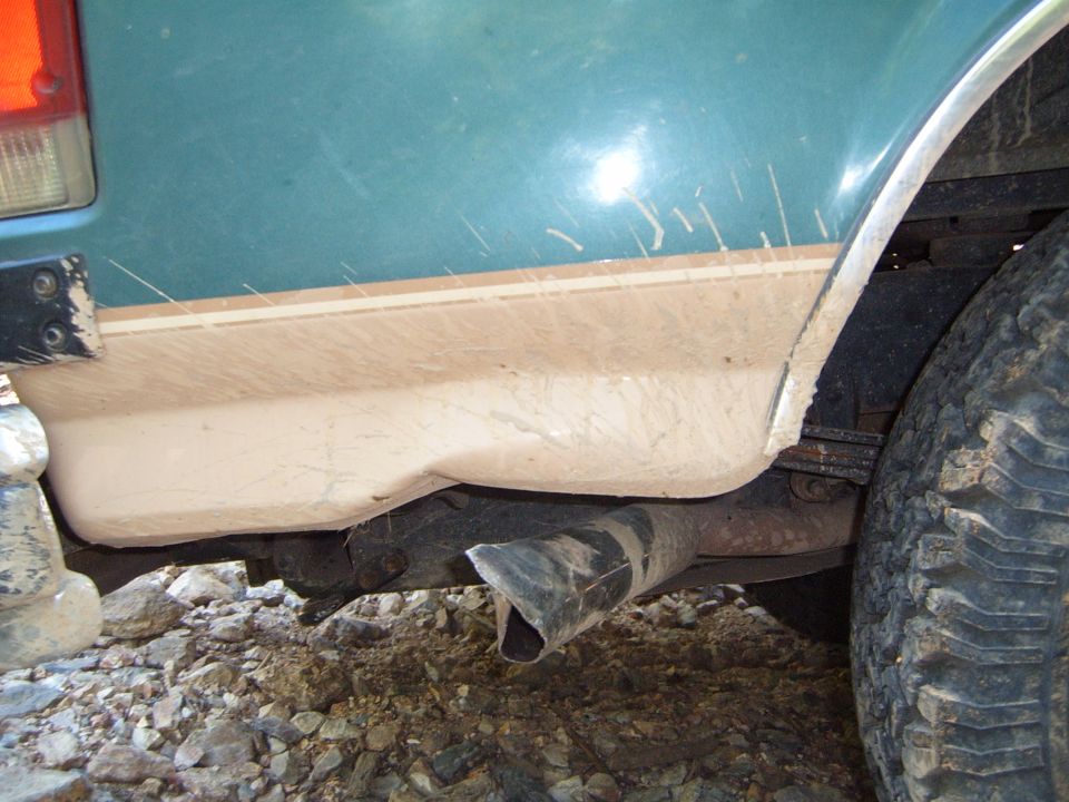 1988 Ford Bronco rear quarter panel with two-tone paint and exposed exhaust pipe