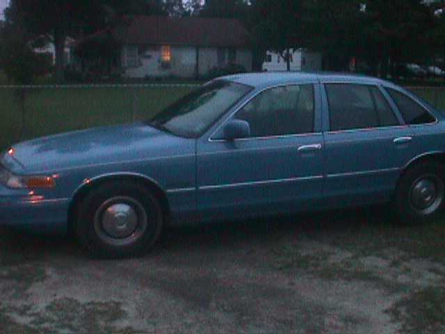 Blue sedan, side view, showing front fender, door, and rear quarter panel. Appears to be a 1992 model