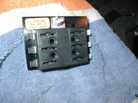 1979 Ford Bronco - A black Bussmann six-position ATC blade fuse panel lying on a blue and white towel, with an upside-down label reading "BUSS MEXICO ATC FUSE…