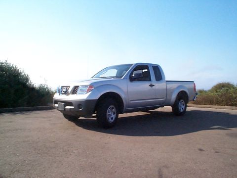 2005 Nissan Frontier - A silver Nissan Frontier pickup truck is parked outdoors under a clear blue sky.