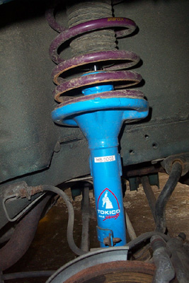 1995 Ford Taurus - Close-up of a Tokico blue shock absorber with a purple spring, the part number MB-5003.