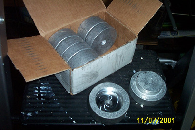 1995 Ford Taurus - Several metal cylindrical parts are shown, some in a box and some outside.