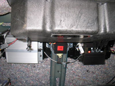 1995 Ford Taurus - Underside view of car interior components, including amplifiers and wiring.