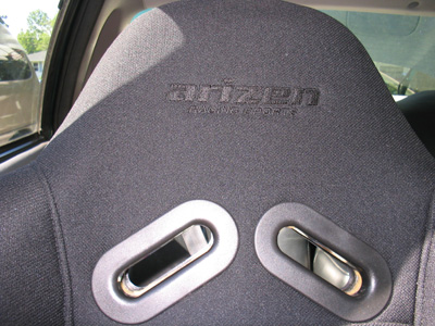 1995 Ford Taurus - Interior view of a racing seat with embroidered branding and harness slots.