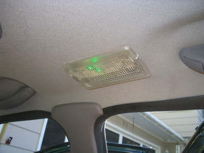 1995 Ford Taurus - The interior dome light assembly shows green LEDs illuminated.