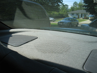 1995 Ford Taurus - View from inside a car, looking out at parked vehicles on a sunny day.