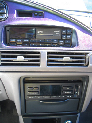 1995 Ford Taurus - Interior view of a 1995 Ford Taurus, showing the dashboard with the Ford radio and climate control system.