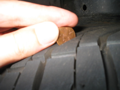 1995 Ford Taurus - Checking tire tread depth with a penny.