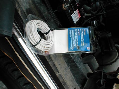 1979 Ford Bronco - A battery isolator installation kit and coiled white wire are shown, possibly for a vehicle's electrical system.