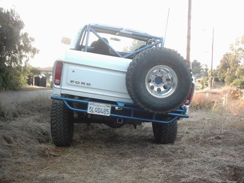 1978 Ford Bronco - This 1978 Ford Bronco features a custom blue roll cage and a rear-mounted spare tire, viewed from the back.