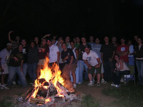 1995 Ford Probe - A group of friends enjoys a nighttime bonfire, with many people posing for the camera.
