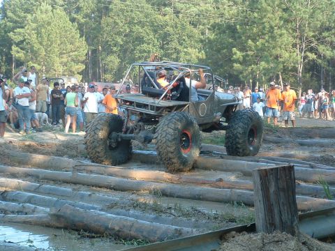 1993 Ford Bronco - Off-road buggy tackles a challenging log course during an event.