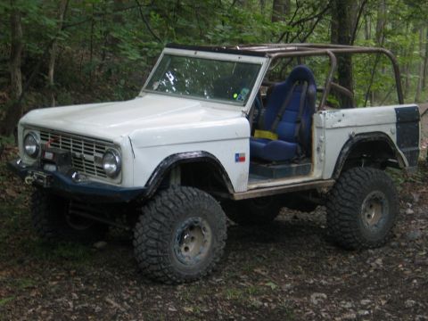 1995 Ford Bronco - Modified first-generation Ford Bronco features a roll cage and racing seat for off-road use.