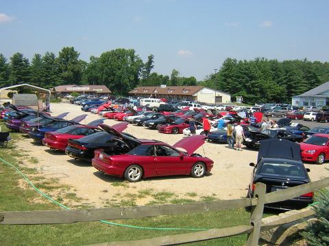 1995 Ford Probe - A gathering of Ford Probes, mostly with hoods open, parked outdoors on a sunny day.