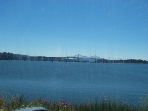 1994 Ford F-150 - A bridge crosses a large body of water with trees on the far bank.