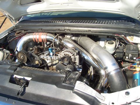 1994 Ford F-150 - Custom turbo piping installed in an engine bay, showing modified intake and exhaust systems.
