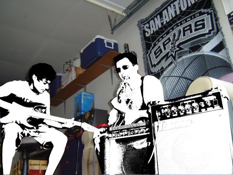 1988 Ford LTD Crown Victoria - Two musicians practice in a garage with a San Antonio Spurs blanket hanging on the wall.