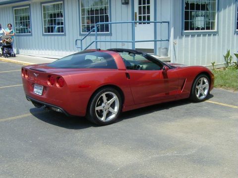 1994 Ford Probe - A red Chevrolet Corvette is parked in a lot, viewed from the rear three-quarter angle.