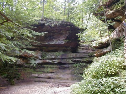 1994 Ford Probe - A scenic view of a canyon with layered rock formations, lush greenery, and a wooden walkway on the right side.