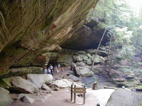 1994 Ford Probe - A group explores a natural cave formation with signs indicating nearby attractions.