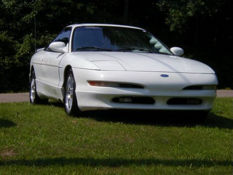 1994 Ford Probe - A white 1994 Ford Probe is parked on a grassy lawn, viewed from the front.