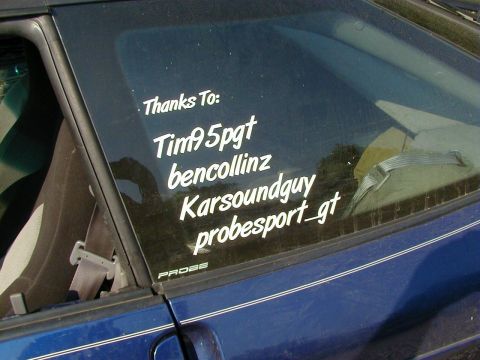 1994 Ford Probe - Car window displays thank you messages and a 'PROBE' badge, with a Supermotors watermark at the bottom.