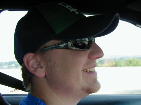 1994 Ford Probe - Close-up of a person wearing a baseball cap and sunglasses while inside a vehicle.