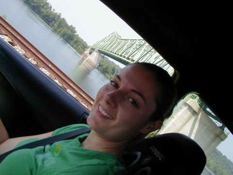 1994 Ford Probe - Selfie taken from inside a vehicle, showing a woman and a bridge over a river.