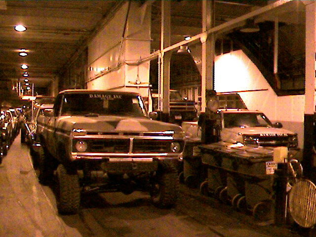 Camouflaged 1977 Ford F-150 pickup truck with lifted suspension, seen from the front
