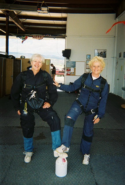 1972 Ford Ranchero - Two women in skydiving jumpsuits are ready for their jump, posing playfully for the camera.