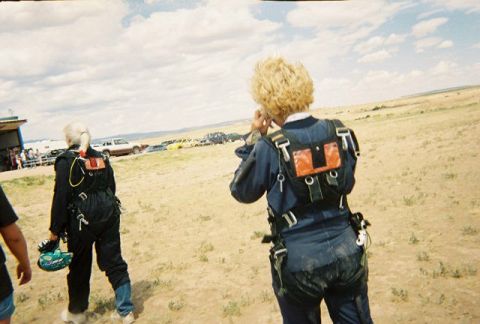 1972 Ford Ranchero - Skydiving participants prepare at a dropzone with a line of vehicles parked nearby.