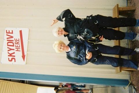 1972 Ford Ranchero - Two women in skydiving gear pose for a photo next to a sign indicating where to skydive.