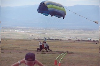 1972 Ford Ranchero - A parachute is seen descending over a field where several people are gathered.