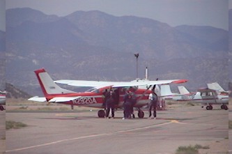 1972 Ford Ranchero - Several small aircraft parked on an airfield with mountains in the background.