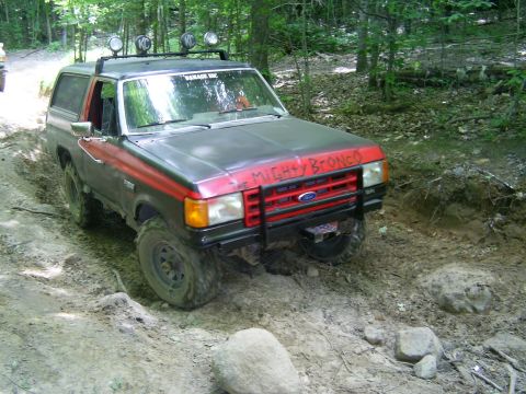 1977 Ford F-150 - This Ford Bronco is navigating a challenging, muddy off-road course.