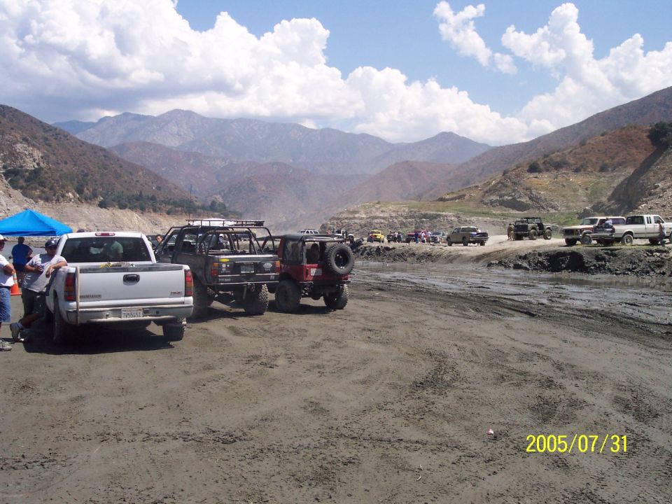 Off-road vehicles gathered in a dusty, mountainous area with a date stamp of 2005/07/31