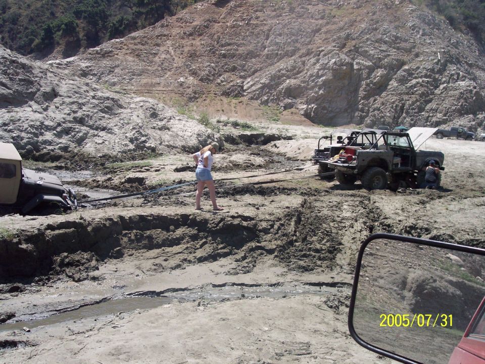 didnt understand this...two trucks trying to yank him thru the mud.