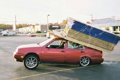 1972 Ford Ranchero - This car is dangerously overloaded with building materials, with the load extending far beyond the vehicle's dimensions.
